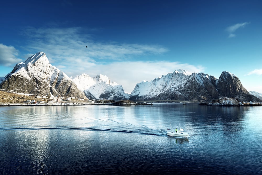 snowy mountains over a lake